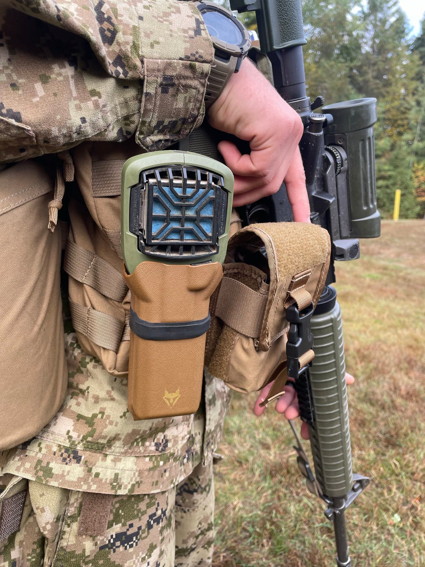 Coyote Skeeter Thermacell MR300 Carrier mounted on MOLLE gear during outdoor training