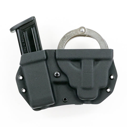 Vesta Kydex carrier holding chained handcuffs and a double-stack metal pistol magazine