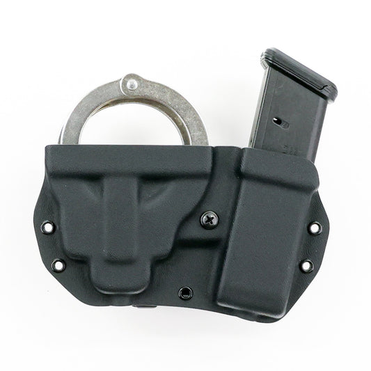Vesta Kydex carrier holding chained handcuffs and a double-stack Glock pistol magazine