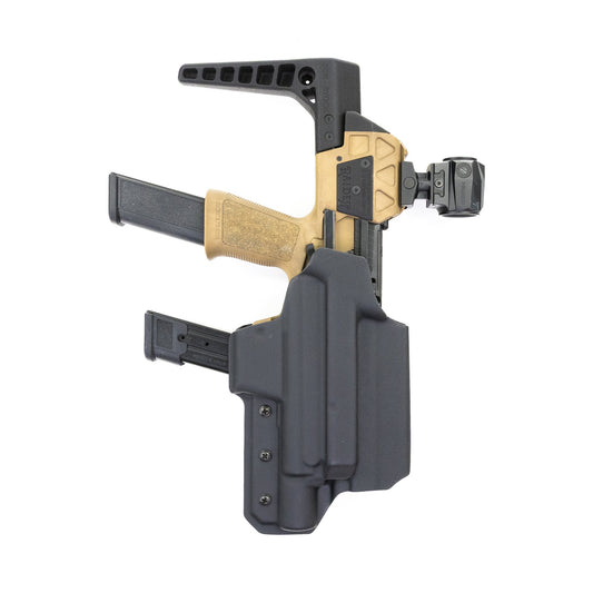 Black Capacitor OWB holster carrying a Flux Defense Raider X – front view