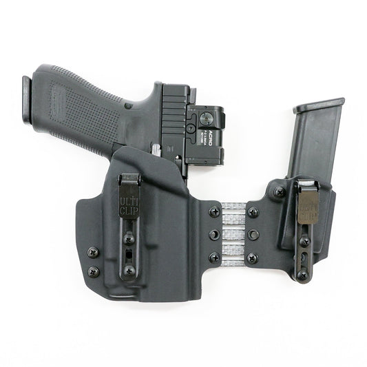 Front view of the Umbra light-bearing appendix holster system showing dual UltiClip Slim 3.3 clips and adjustable Tegris bridge